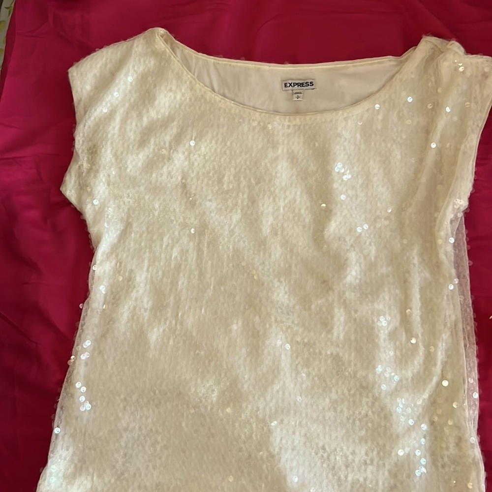 Wear this off white sequin top for a night out on the town or date night